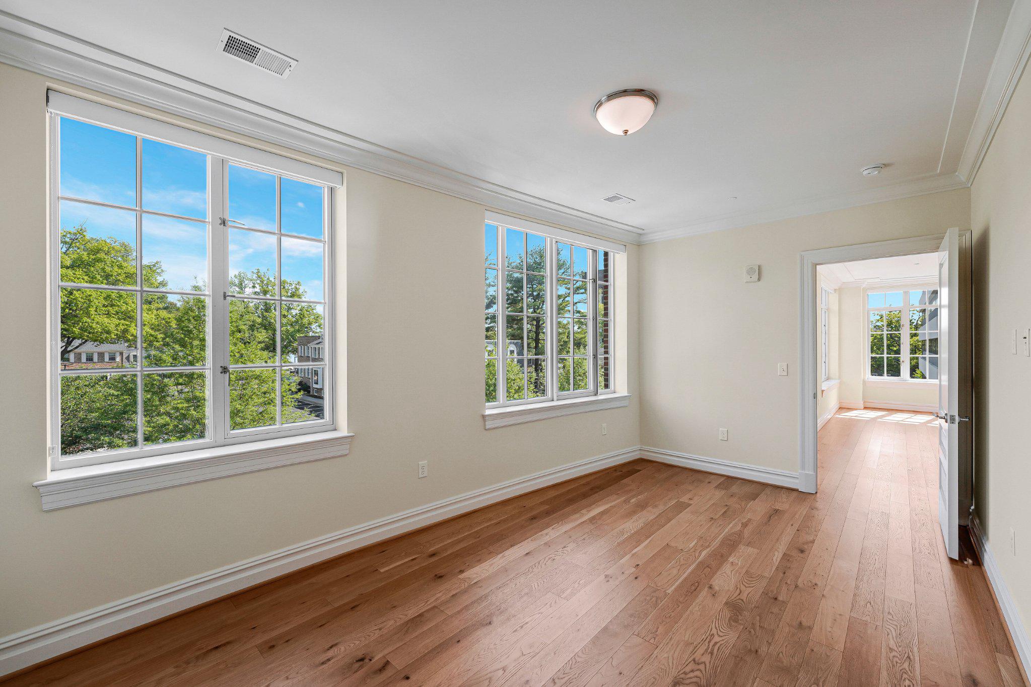 6900 Fleetwood Road, Unit 318 McLean, VA 22101 - Photo 22 of 63 a view of an empty room with wooden floor and a window