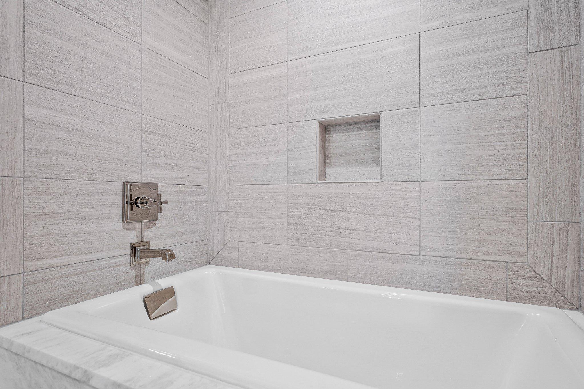 6900 Fleetwood Road, Unit 318 McLean, VA 22101 - Photo 25 of 63 a bathroom with a white bath tub and a shower