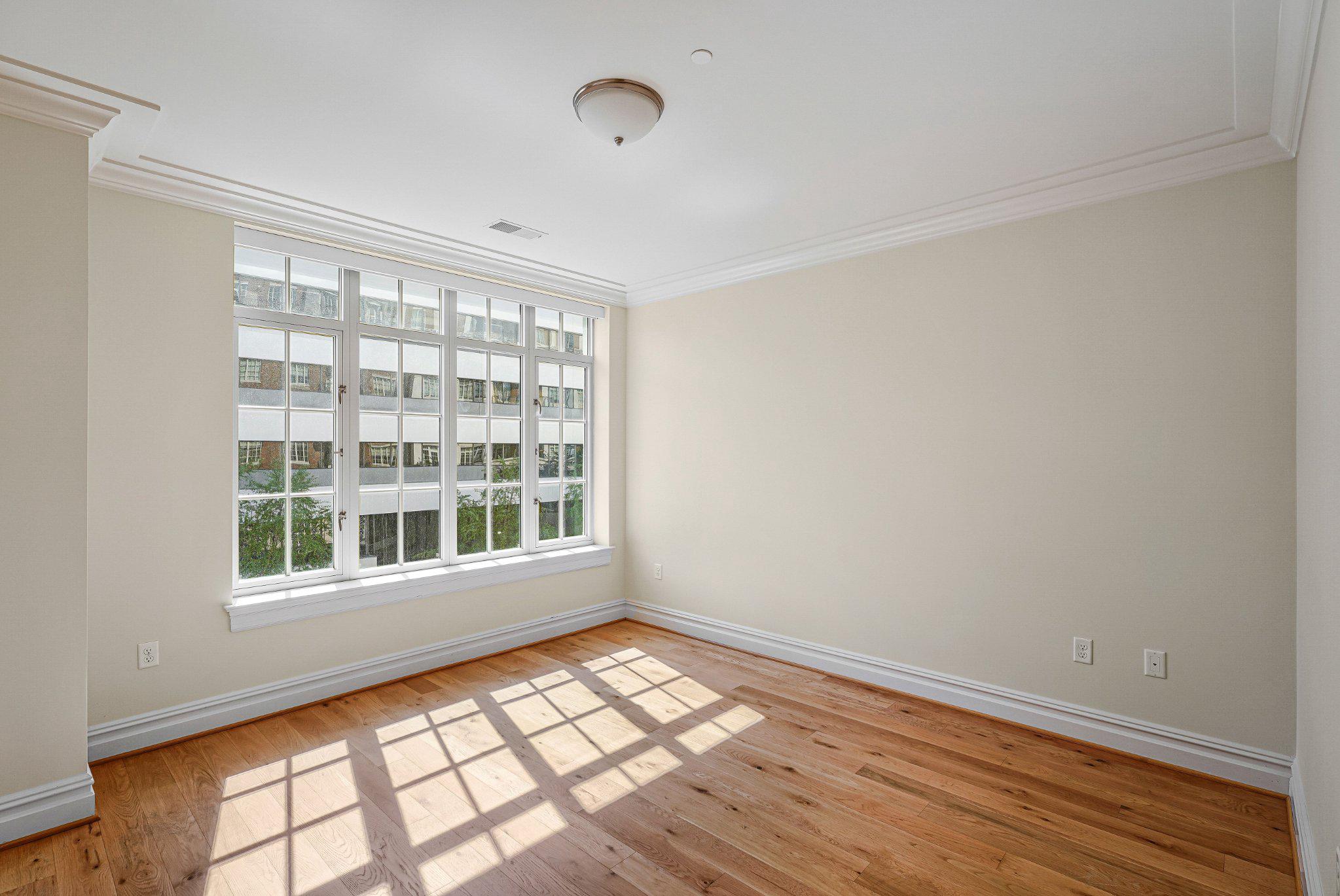 6900 Fleetwood Road, Unit 318 McLean, VA 22101 - Photo 27 of 63 a view of an empty room with wooden floor and a window