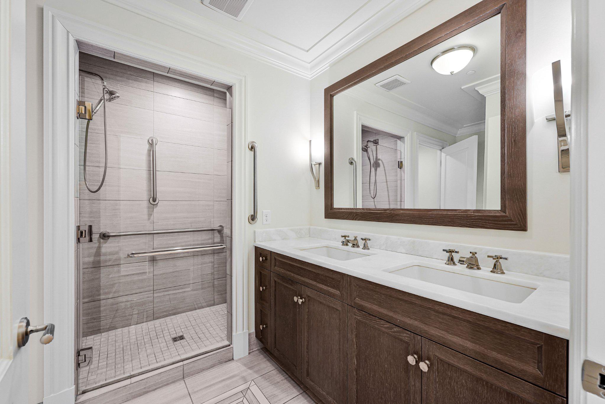 6900 Fleetwood Road, Unit 318 McLean, VA 22101 - Photo 29 of 63 a bathroom with a shower sink and mirror