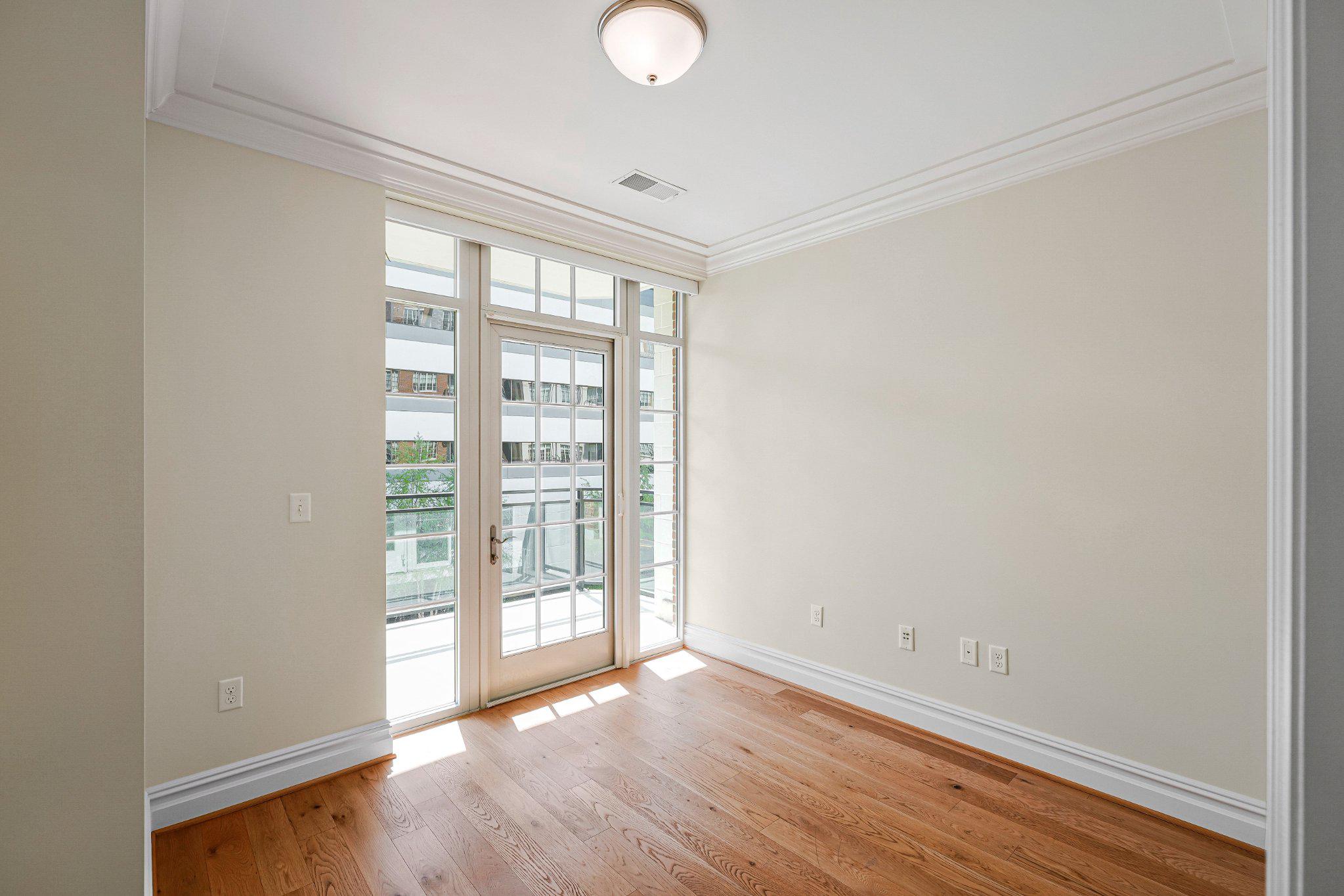6900 Fleetwood Road, Unit 318 McLean, VA 22101 - Photo 32 of 63 an empty room with wooden floor and windows
