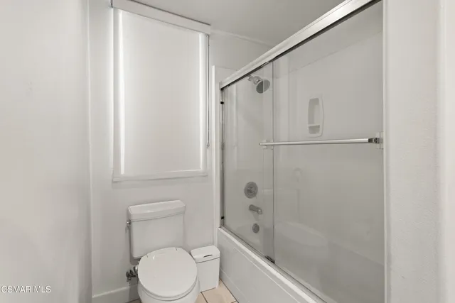 a bedroom with a bed and a desk