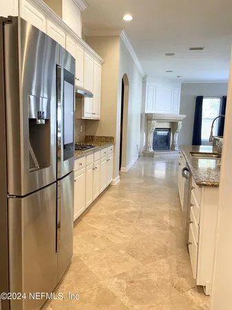 a kitchen with stainless steel appliances granite countertop a refrigerator stove and sink