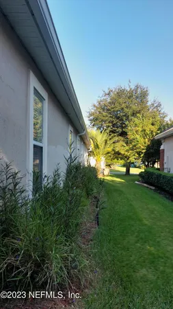 an aerial view of a house with outdoor space and lake view