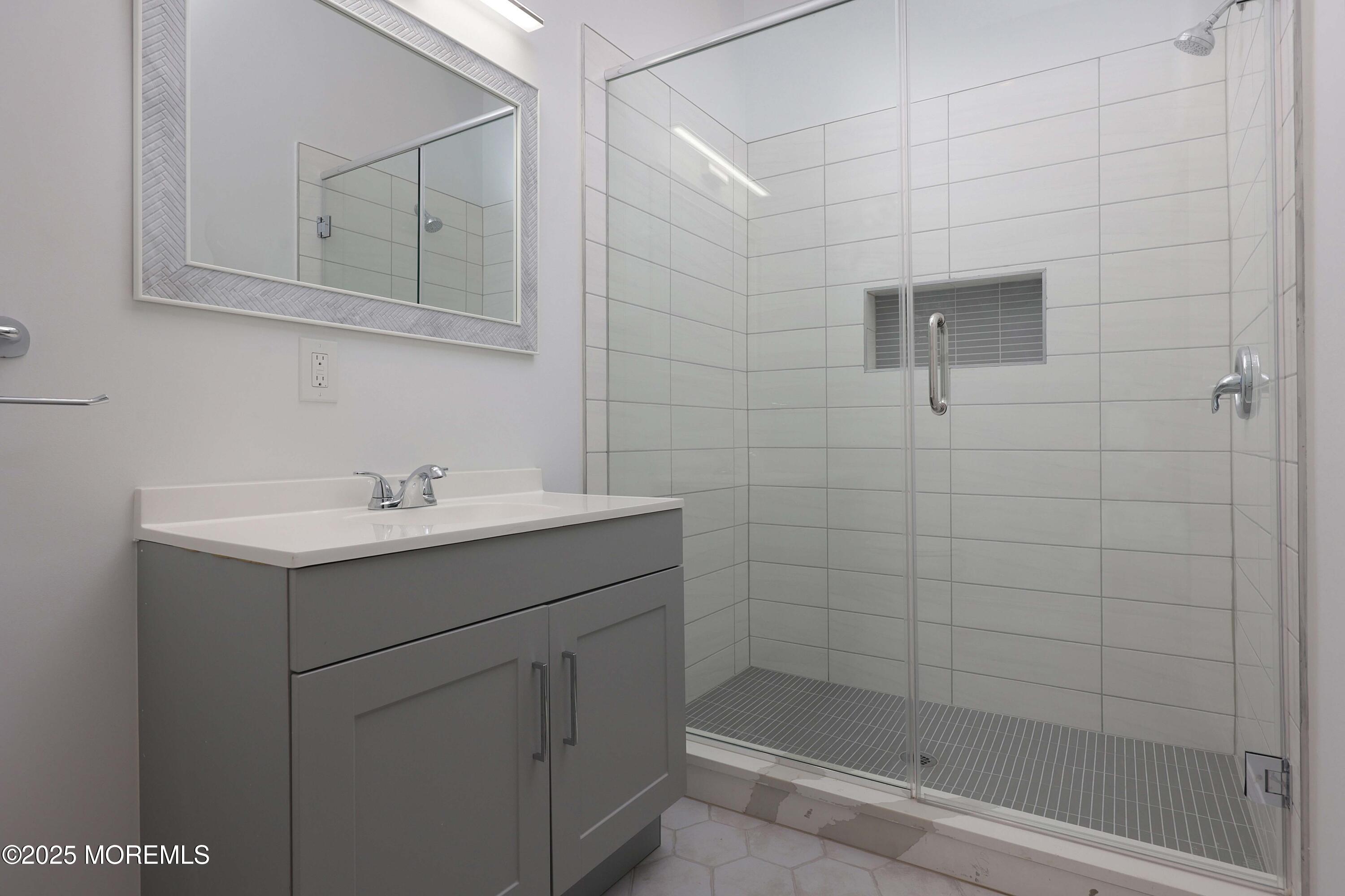 14 East Front Street, Unit 2F Red Bank, NJ 07701 - Photo 13 of 22 a bathroom with a sink a toilet and shower