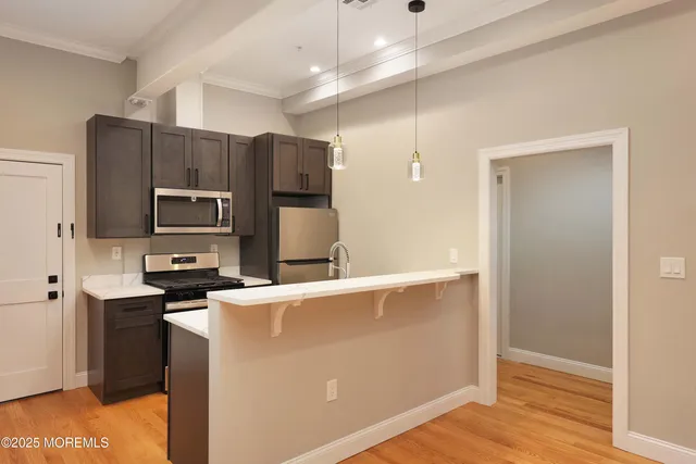 a kitchen with stainless steel appliances a refrigerator and a stove