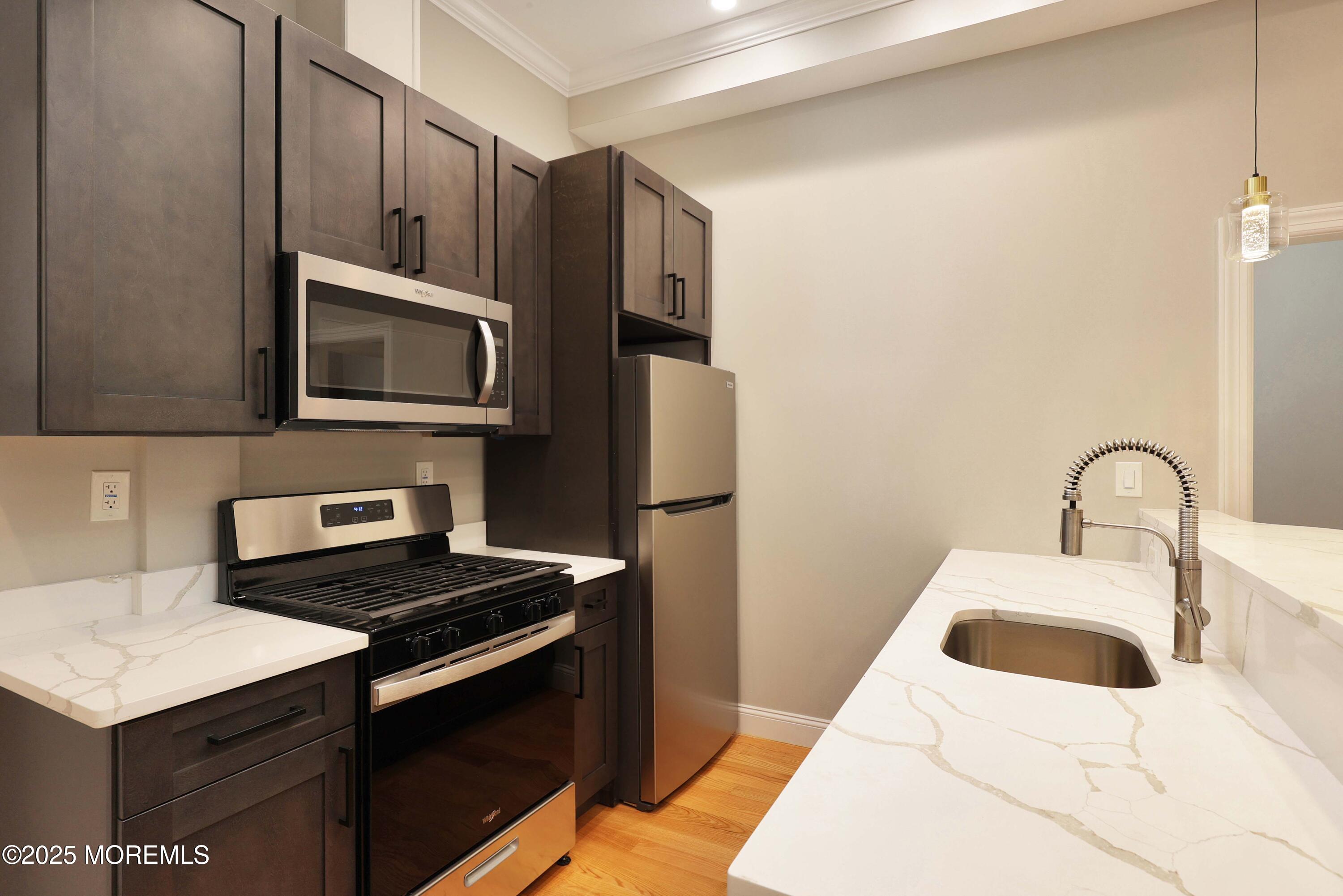 14 East Front Street, Unit 2F Red Bank, NJ 07701 - Photo 3 of 22 a kitchen with stainless steel appliances a stove microwave and sink