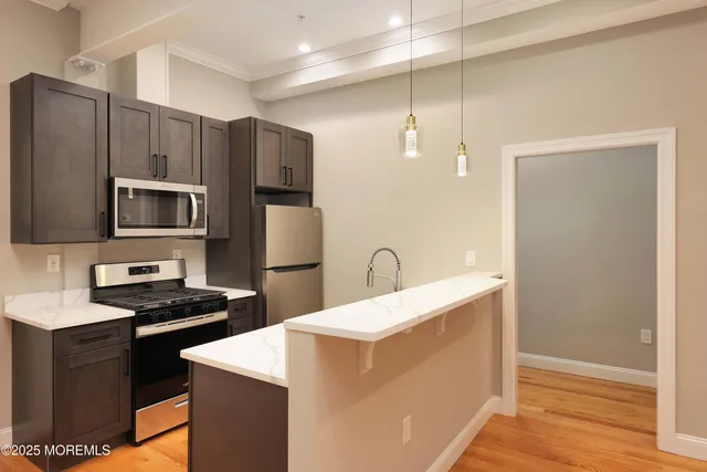 a kitchen with a refrigerator sink and stove