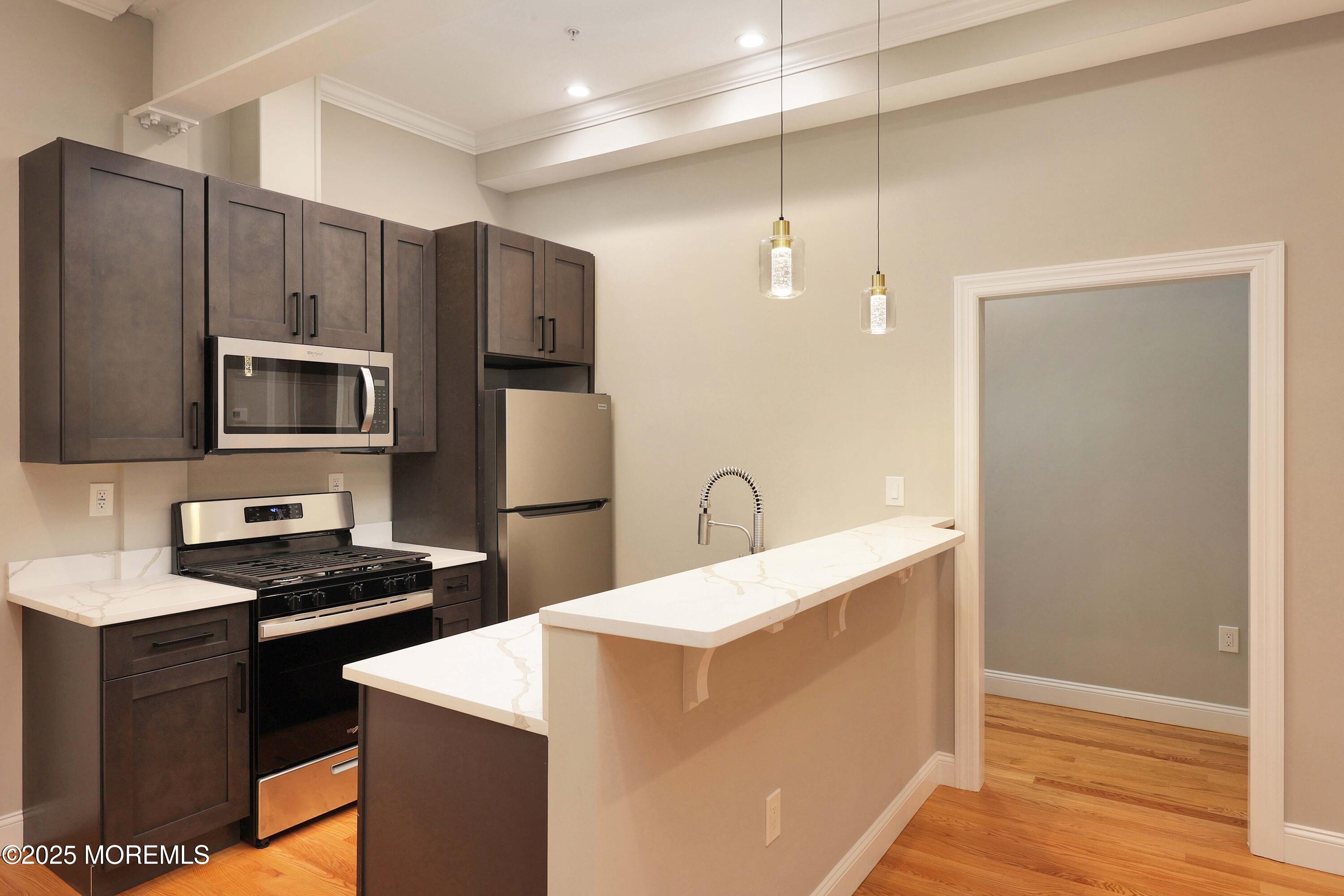 14 East Front Street, Unit 2F Red Bank, NJ 07701 - Photo 4 of 22 a kitchen with a refrigerator sink and stove
