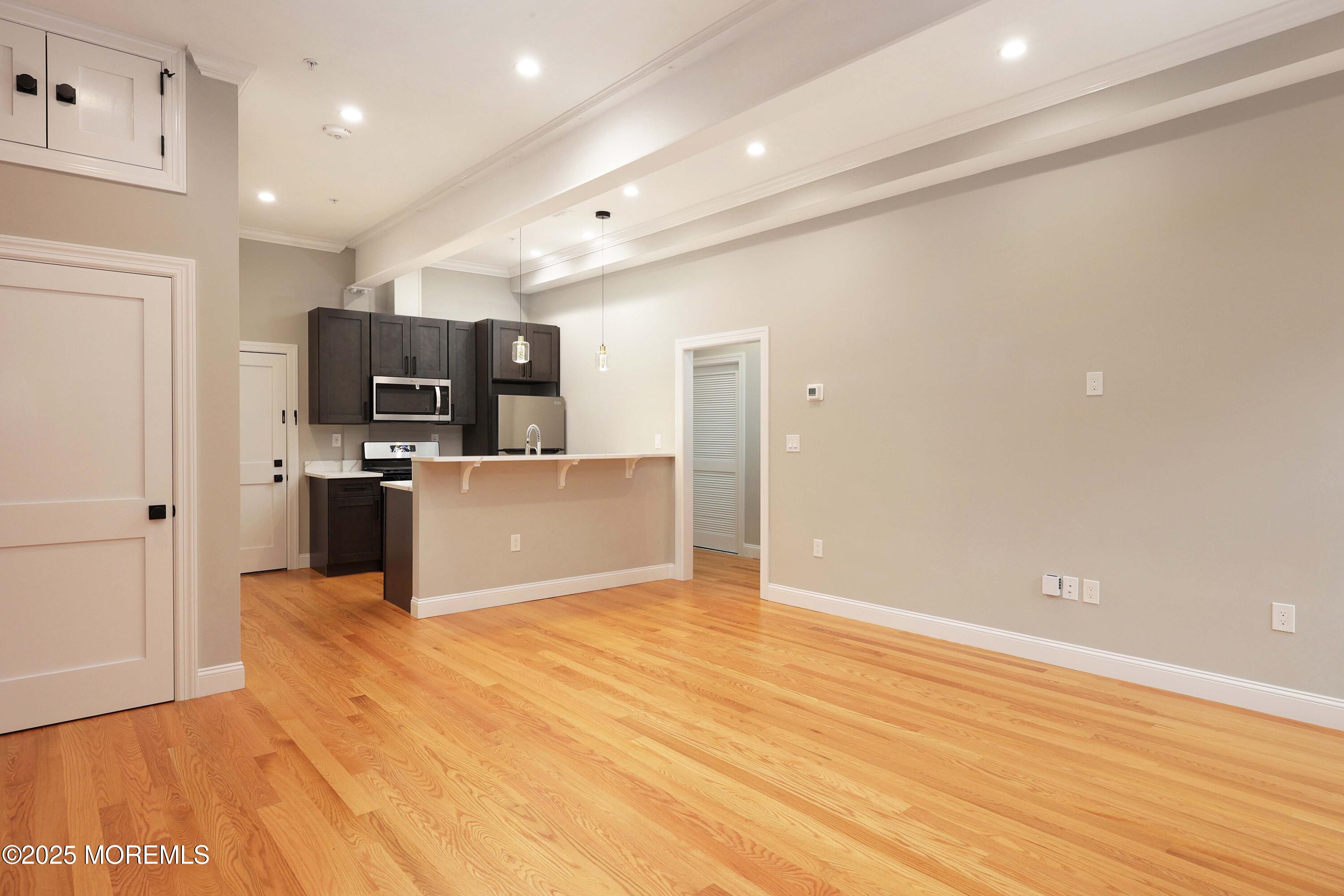 14 East Front Street, Unit 2F Red Bank, NJ 07701 - Photo 7 of 22 a view of kitchen with microwave oven a refrigerator and a sink