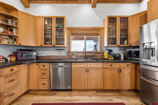 a kitchen with stainless steel appliances granite countertop a stove a sink and a microwave