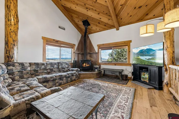 a living room with furniture a fireplace and a flat screen tv