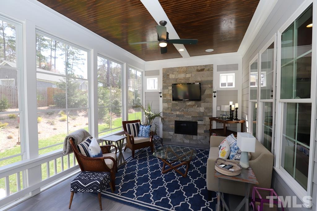 8624 Wapello Lane Raleigh, NC 27613 - Photo 14 of 26 a living room with furniture fireplace and a large window