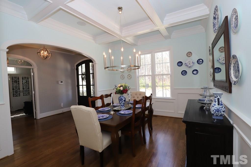 8624 Wapello Lane Raleigh, NC 27613 - Photo 3 of 26 a view of a a dining room with furniture window and wooden floor