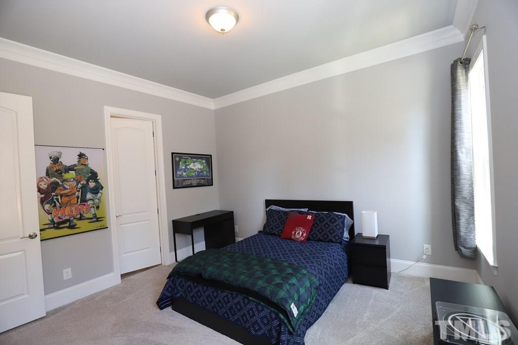 8624 Wapello Lane Raleigh, NC 27613 - Photo 22 of 26 a bedroom with a bed and cabinets