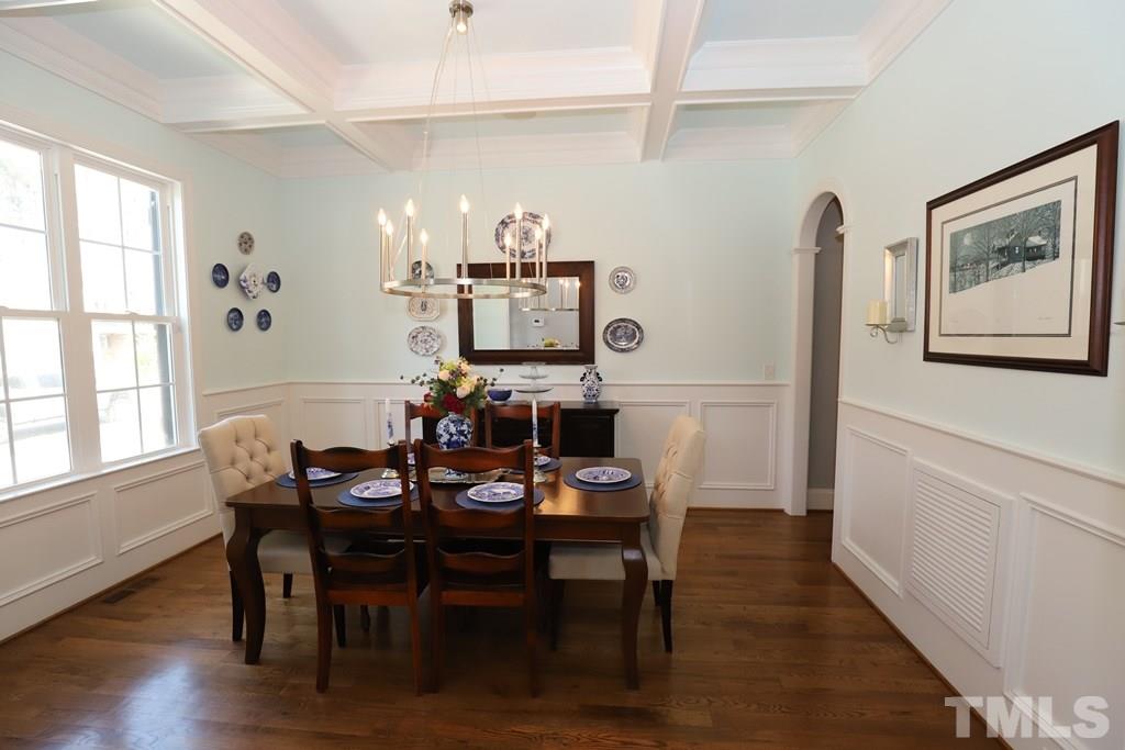 8624 Wapello Lane Raleigh, NC 27613 - Photo 4 of 26 a view of a dining room with furniture window and wooden floor