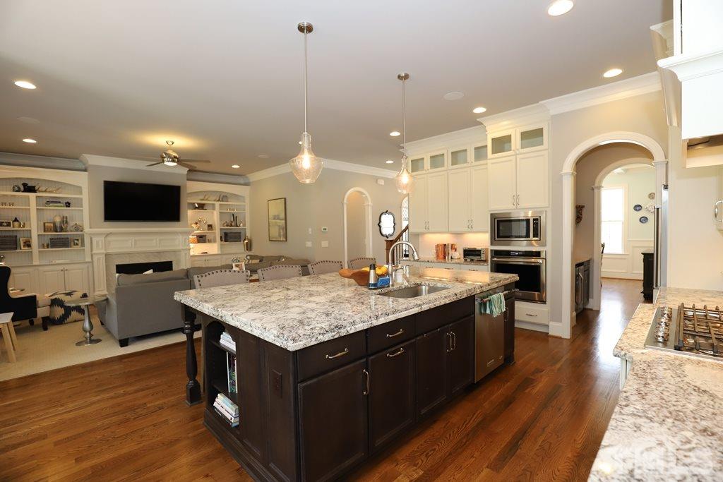 8624 Wapello Lane Raleigh, NC 27613 - Photo 8 of 26 a kitchen with stainless steel appliances granite countertop wooden cabinets and sink