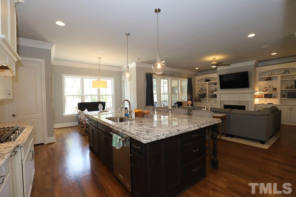 8624 Wapello Lane Raleigh, NC 27613 - Photo 9 of 26 a large kitchen with stainless steel appliances granite countertop a lot of counter tops and a view of living room