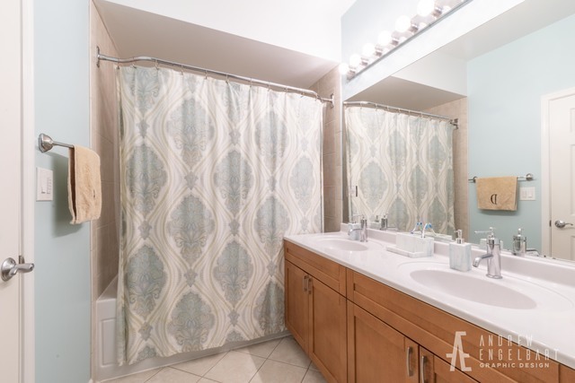 757 West 14th Street, Unit 1B Chicago, IL 60607 - Photo 10 of 13 a bathroom with a double vanity sink and a mirror