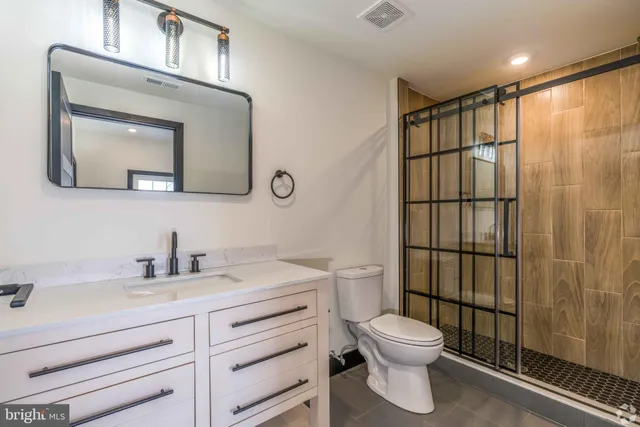a bathroom with a toilet a sink and mirror