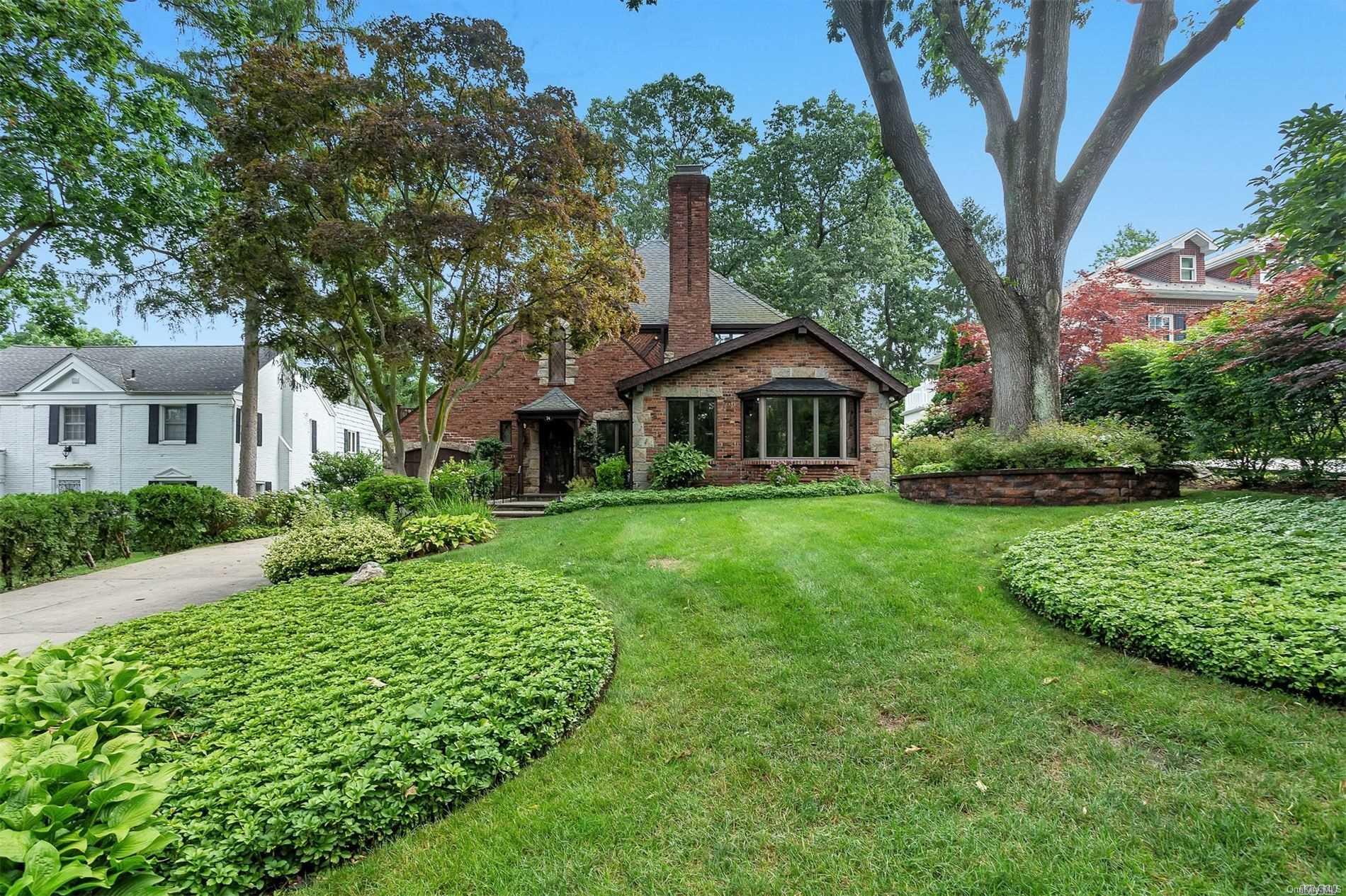 74 Knickerbocker Road Manhasset, NY 11030 - Photo 1 of 1 a front view of a house with a yard