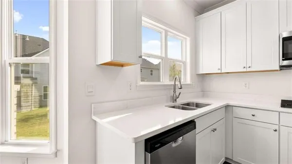 a kitchen with stainless steel appliances cabinets a sink and a window