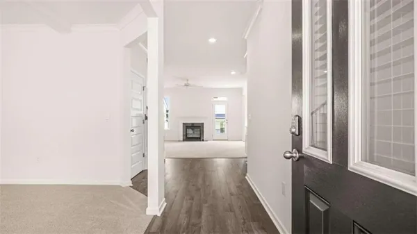 a view of a hallway with wooden floor and staircase