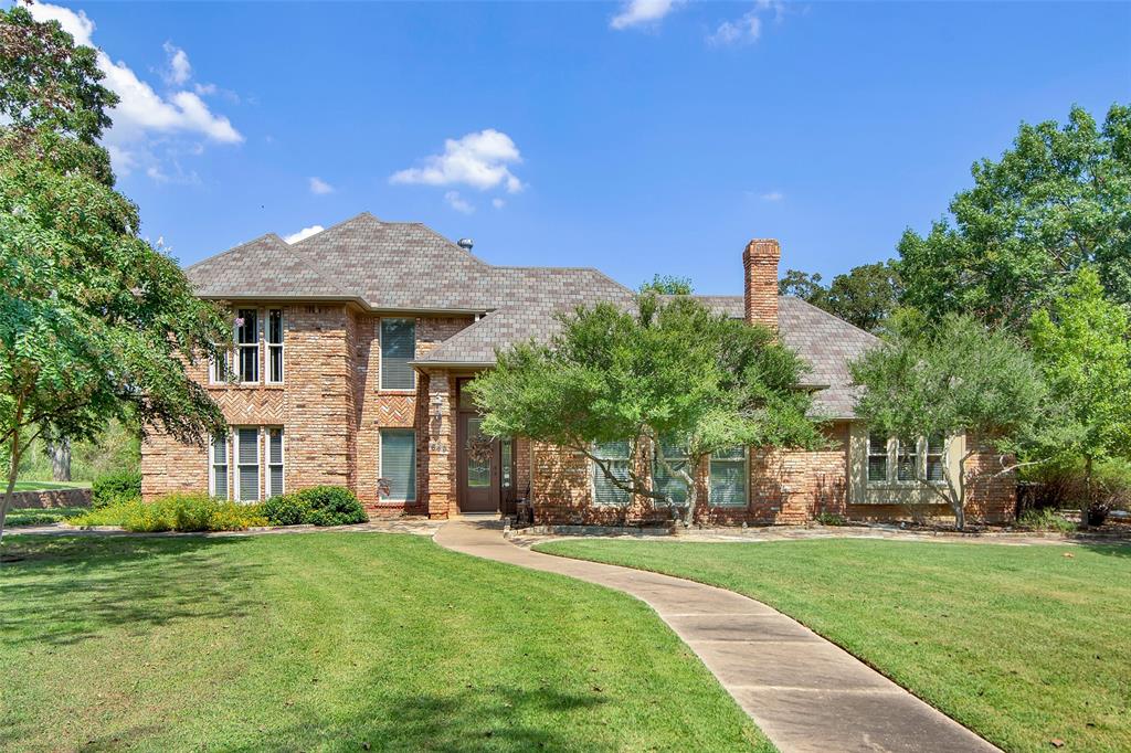 649 Anderson Road Whitesboro, TX 76273 - Photo 1 of 40 a front view of a house with a garden
