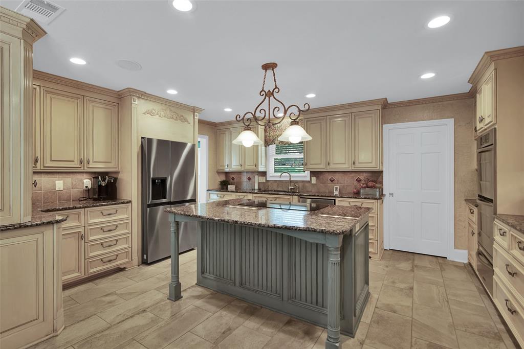 649 Anderson Road Whitesboro, TX 76273 - Photo 12 of 40 a kitchen with stainless steel appliances a sink stove and refrigerator