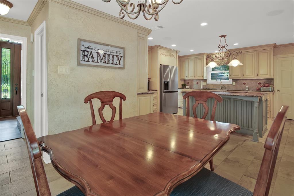649 Anderson Road Whitesboro, TX 76273 - Photo 17 of 40 a kitchen with kitchen island a dining table chairs stainless steel appliances and cabinets