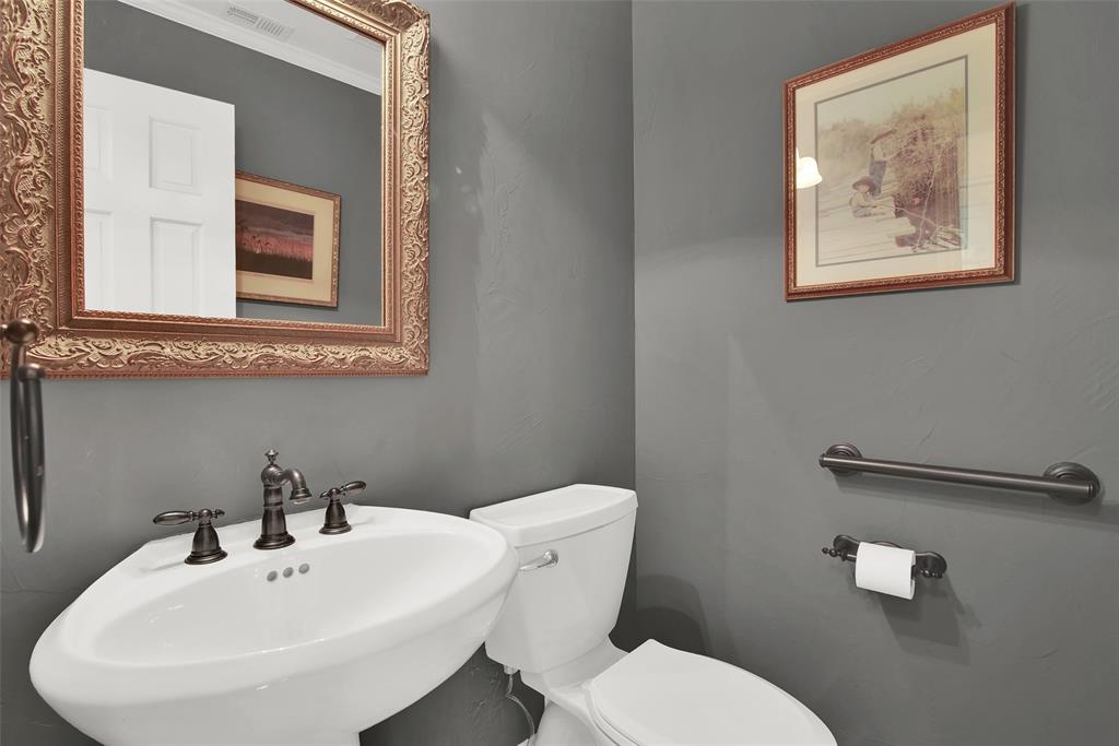 649 Anderson Road Whitesboro, TX 76273 - Photo 19 of 40 a bathroom with a toilet a sink and mirror