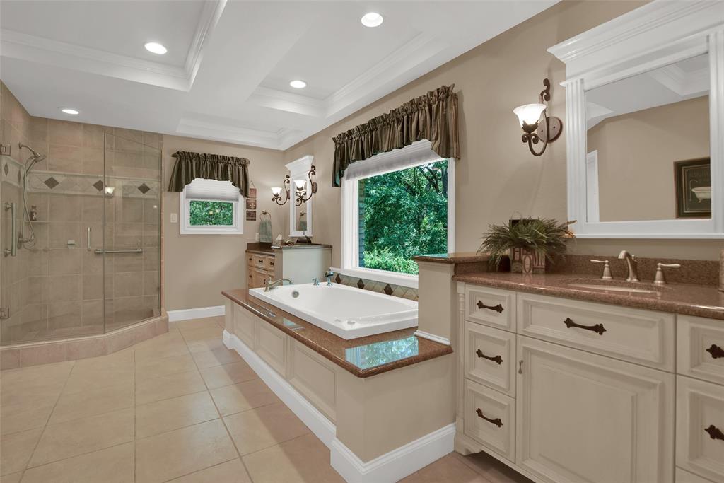 649 Anderson Road Whitesboro, TX 76273 - Photo 22 of 40 a spacious bathroom with a double vanity sink a mirror and a shower