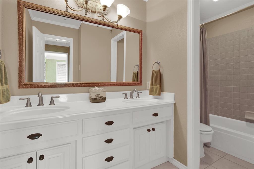 649 Anderson Road Whitesboro, TX 76273 - Photo 23 of 40 a bathroom with a sink a toilet and a mirror