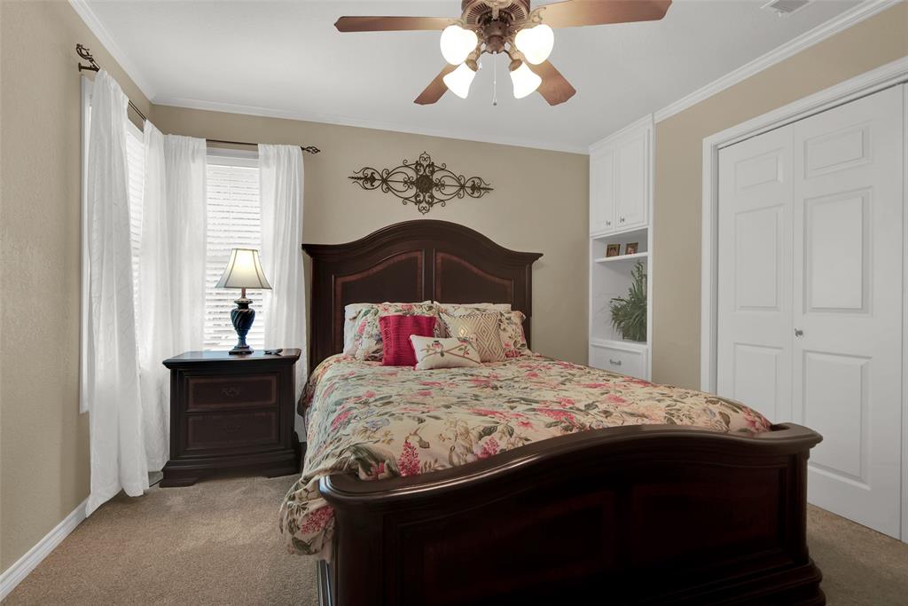649 Anderson Road Whitesboro, TX 76273 - Photo 26 of 40 a bedroom with a bed and a chandelier