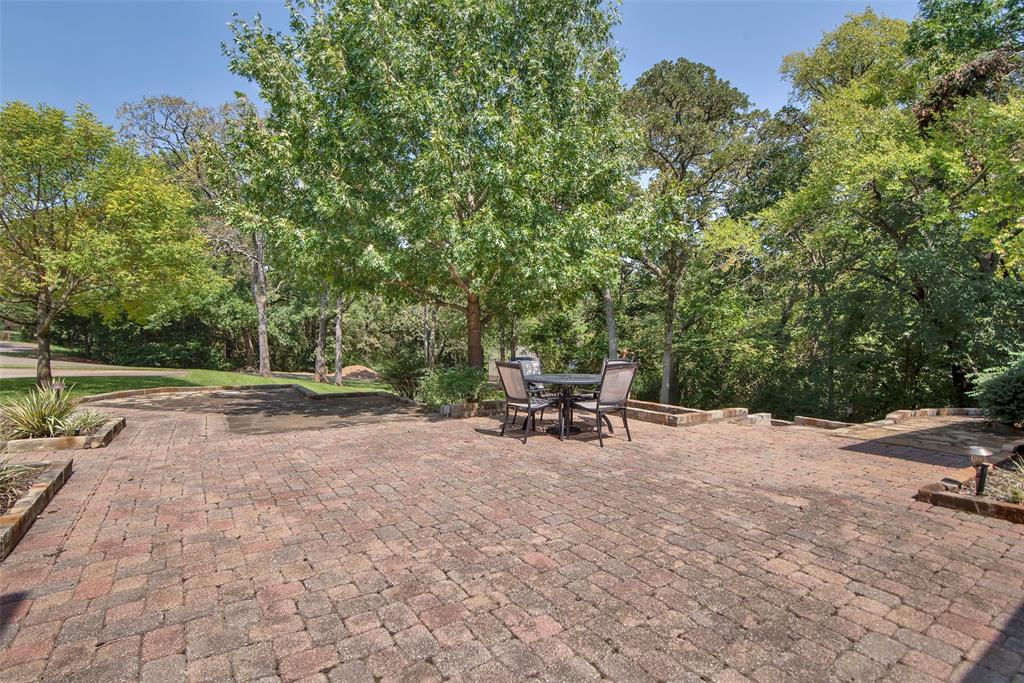 649 Anderson Road Whitesboro, TX 76273 - Photo 29 of 40 a view of backyard with a table and chairs under an umbrella