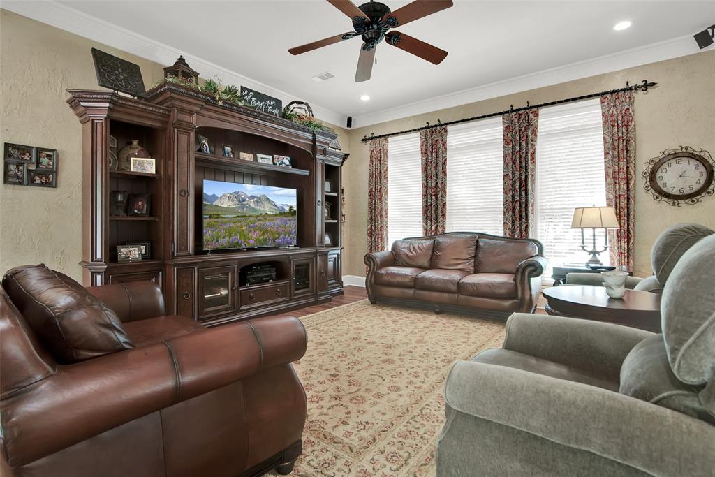 649 Anderson Road Whitesboro, TX 76273 - Photo 6 of 40 a living room with furniture and a flat screen tv