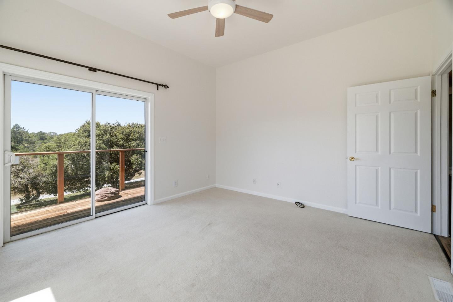 19269 Mallory Canyon Road, Unit D Salinas, CA 93907 - Photo 23 of 77 an empty room with sliding glass door and windows
