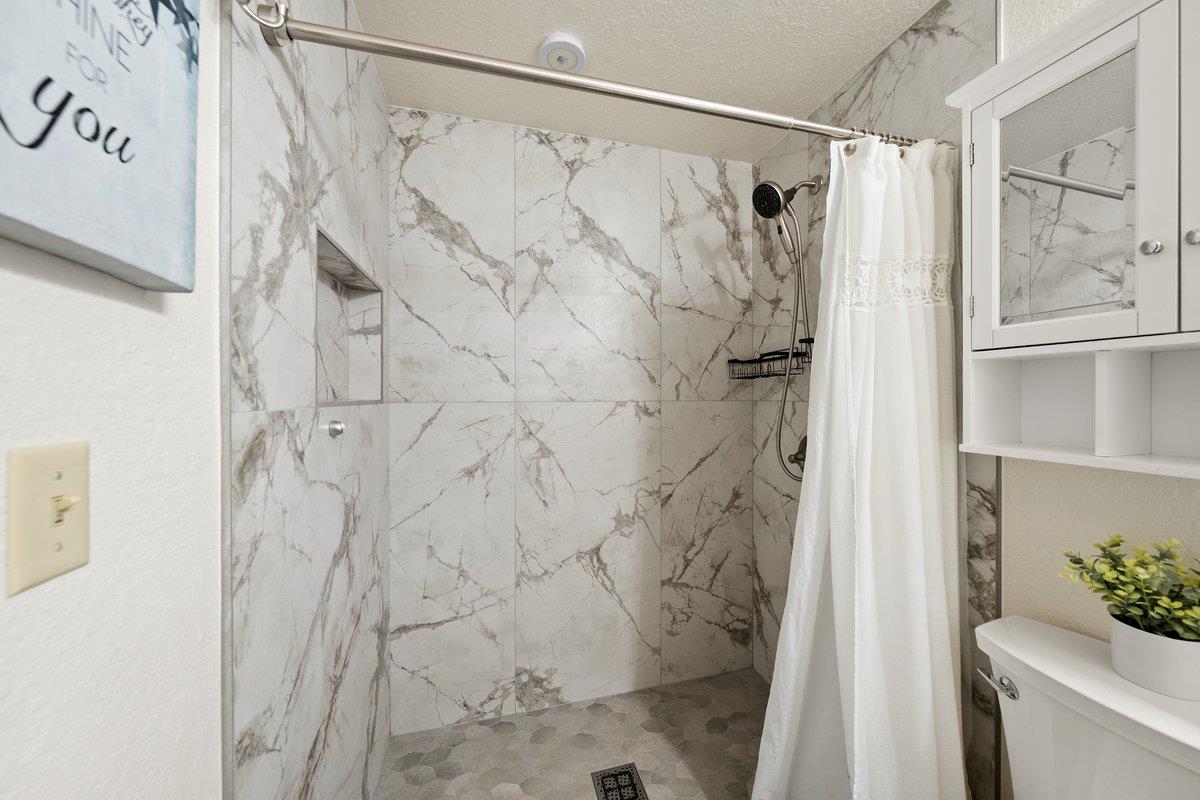 6561 Trinity Way Placerville, CA 95667 - Photo 15 of 58 a bathroom with a shower curtain and a window
