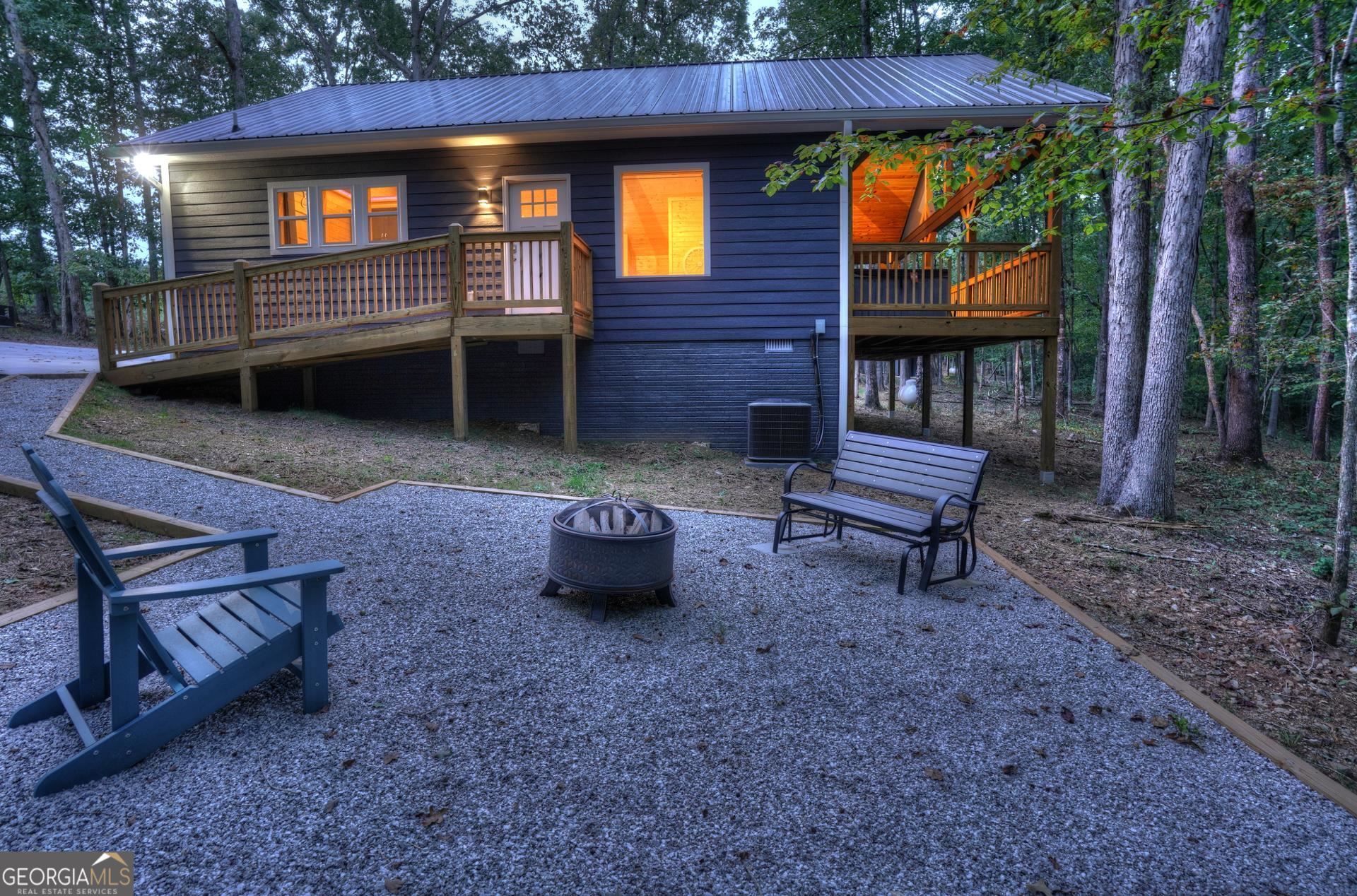 45 Poplar Ridge Drive Cleveland, GA 30528 - Photo 1 of 1 a view of a chairs and fire pit in the backyard