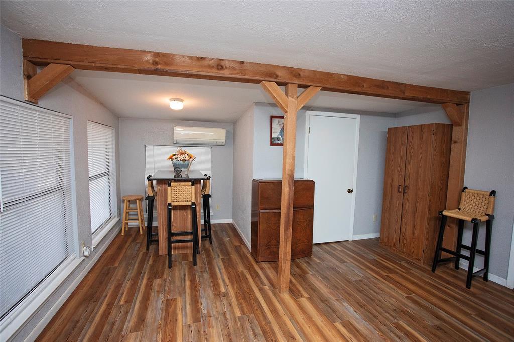 9051 Lacy Road Graford, TX 76449 - Photo 10 of 23 a view of a hallway with wooden floor and furniture