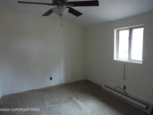 a bedroom with a bed and a desk