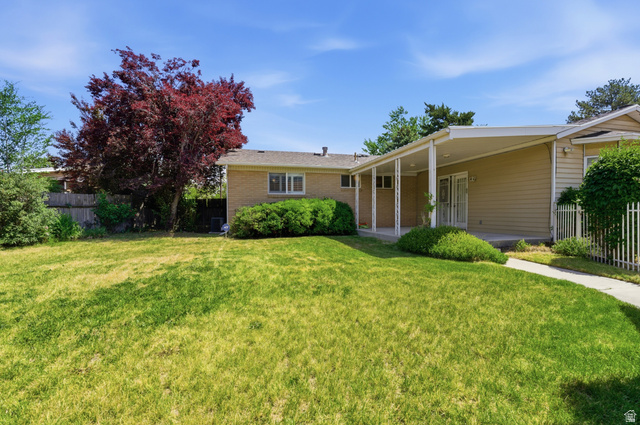 148 Tennyson Avenue Sandy, UT 84070 - Photo 42 of 55 Expansive front lawn with a mature red-leaf tree and established green landscaping