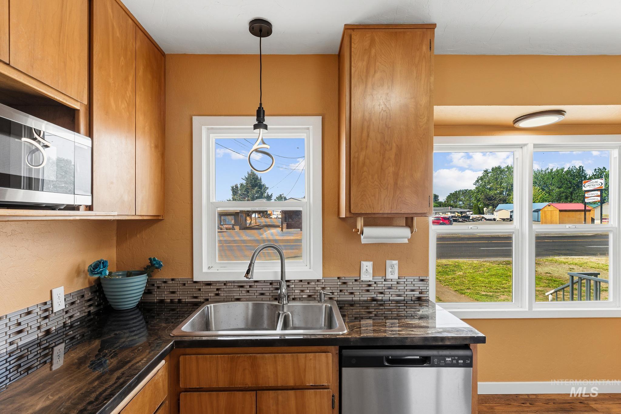 619 Thain Road Lewiston, ID 83501 - Photo 5 of 44 Kitchen featuring wood cabinetry, stainless steel microwave, and stainless steel dishwasher