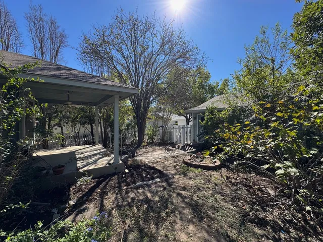 a view of a patio with table and chairs and floor to ceiling window