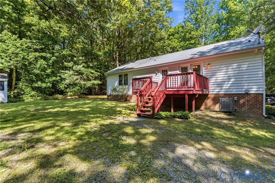12654 Mt Olive Cohoke Road West Point, VA 23181 - Photo 29 of 31 a view of a house with a small yard and deck