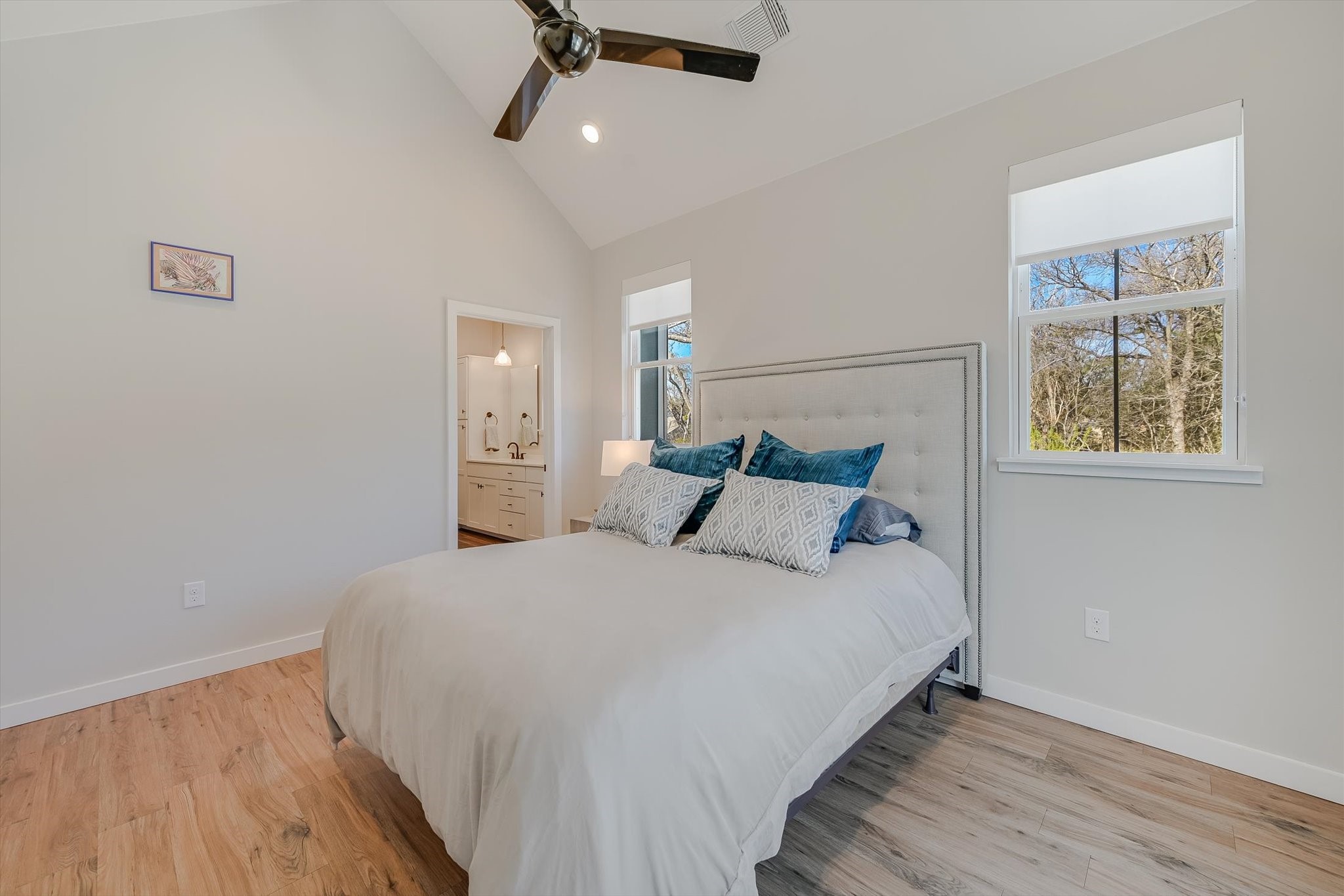 3809 Valley View Road, Unit 7 Austin, TX 78704 - Photo 12 of 21 Bedroom with ceiling fan, ensuite bath, high vaulted ceiling, and light hardwood / wood-style floors