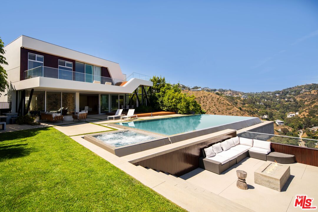 2008 Hercules Drive Los Angeles, CA 90046 - Photo 1 of 36 a view of swimming pool with seating space and trees in the background