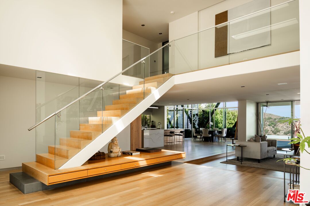 2008 Hercules Drive Los Angeles, CA 90046 - Photo 18 of 36 a view of staircase with furniture and lots of frames on wall