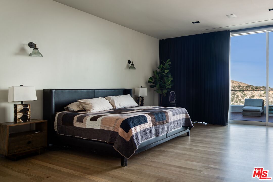 2008 Hercules Drive Los Angeles, CA 90046 - Photo 21 of 36 a bedroom with a bed and a potted plant