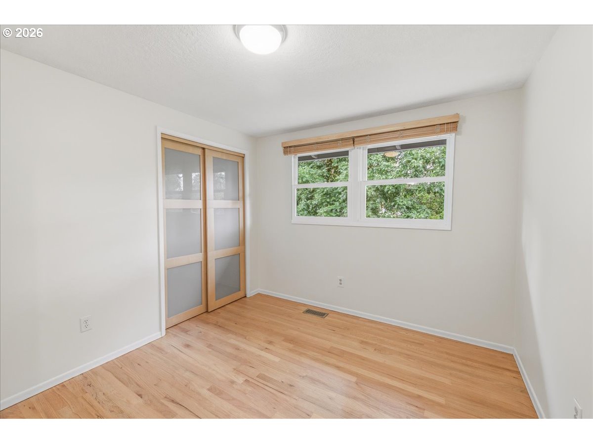 3130 Southwest 116th Avenue Beaverton, OR 97005 - Photo 5 of 44 an empty room with wooden floor and windows